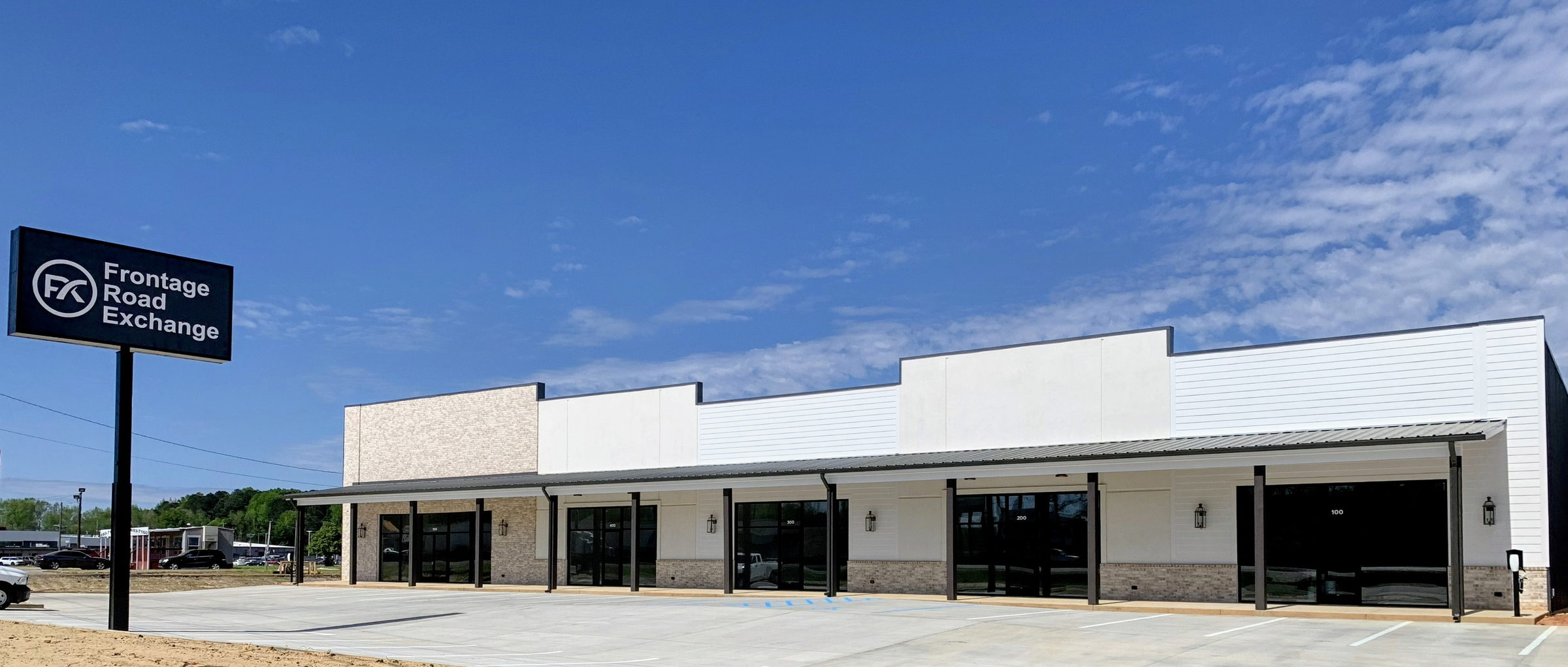 Frontage Road Exchange at 900 N Frontage Rd, Meridian MS — the full storefront elevation with the monument sign on I-20/59